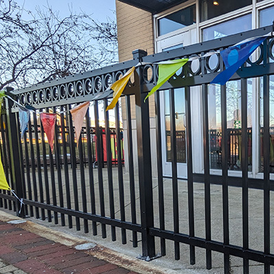 Fence with decorative aluminum circles and butterfly scrolls
